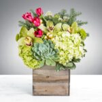 Elegant flower arrangement in a rustic wooden box.