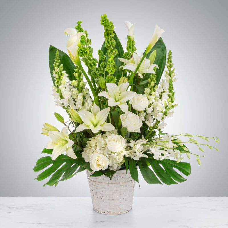Elegant white floral arrangement in a textured white vase.