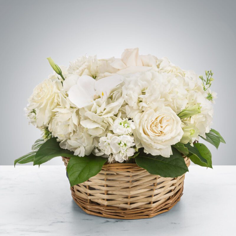 Elegant white flower arrangement in a woven basket.