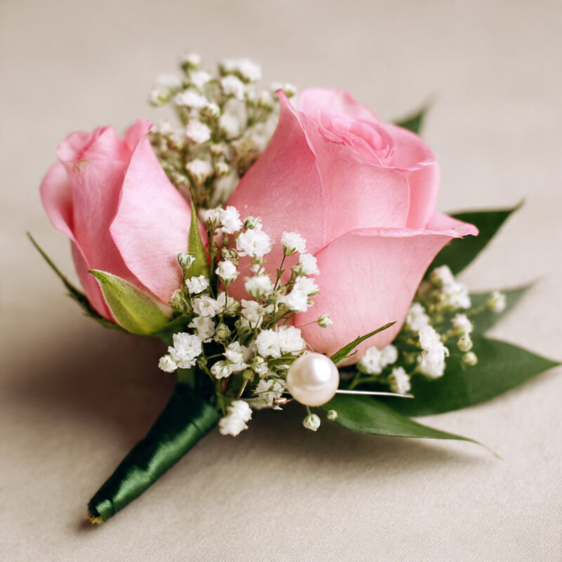 Pink rose boutonniere with greenery by Reema Florist Nashville