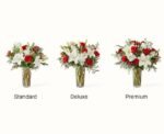 Three variations of the "Twinkle Lights" floral arrangement—Standard, Deluxe, and Premium—featuring red roses, white lilies, and seasonal greenery in glass vases against a white background.