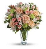 A lush floral arrangement in a clear glass vase featuring peach garden roses, light pink spray roses, white alstroemeria, green hydrangea, and red hypericum berries.