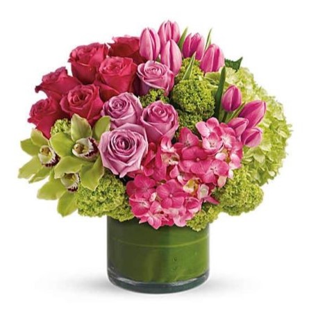 A vibrant mix of roses, tulips, orchids, and hydrangeas in bold pinks and fresh greens — designed to make a statement.